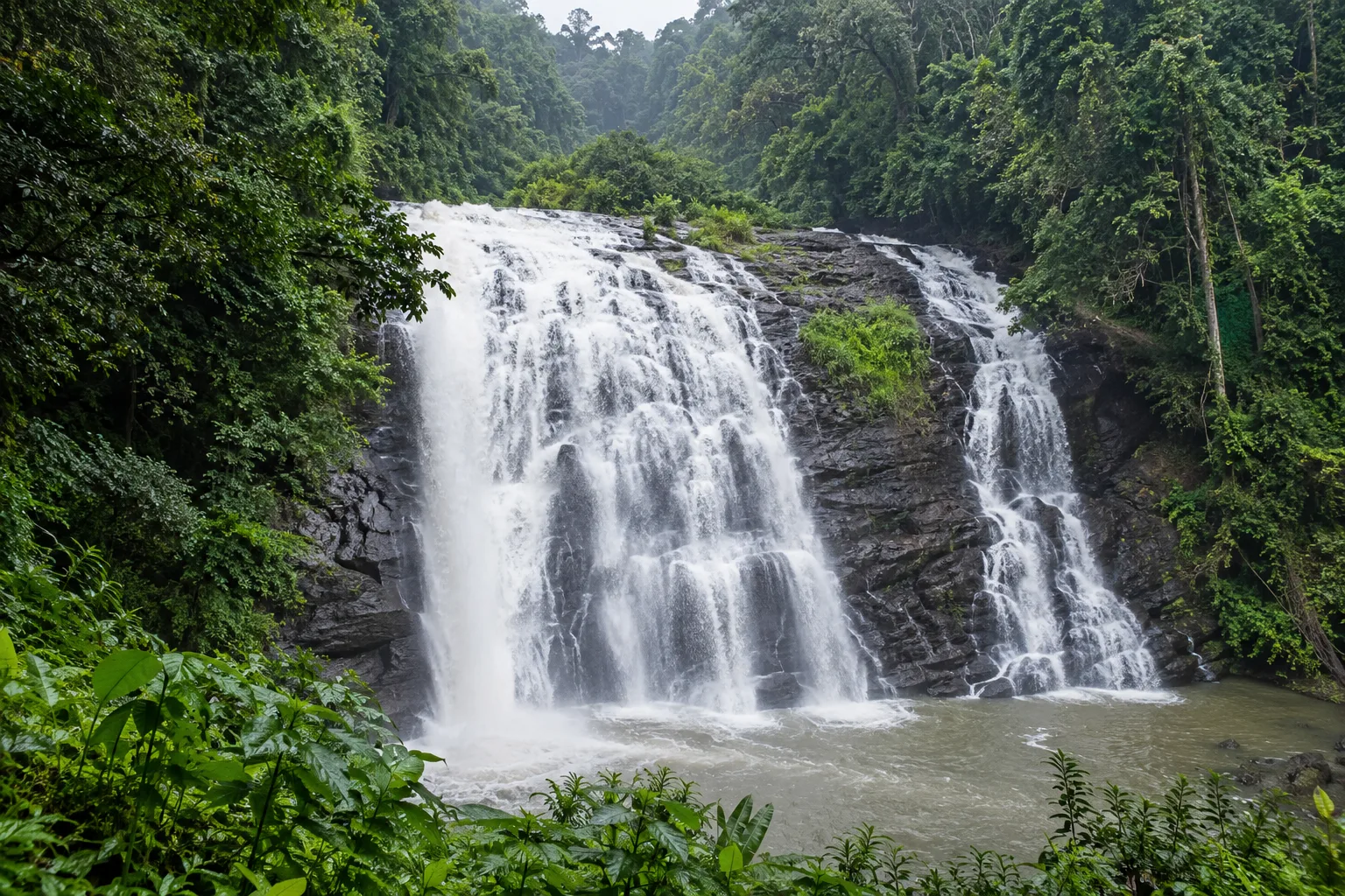 Photorealistic view of Abbey Falls surrounded by dense Coorg forest