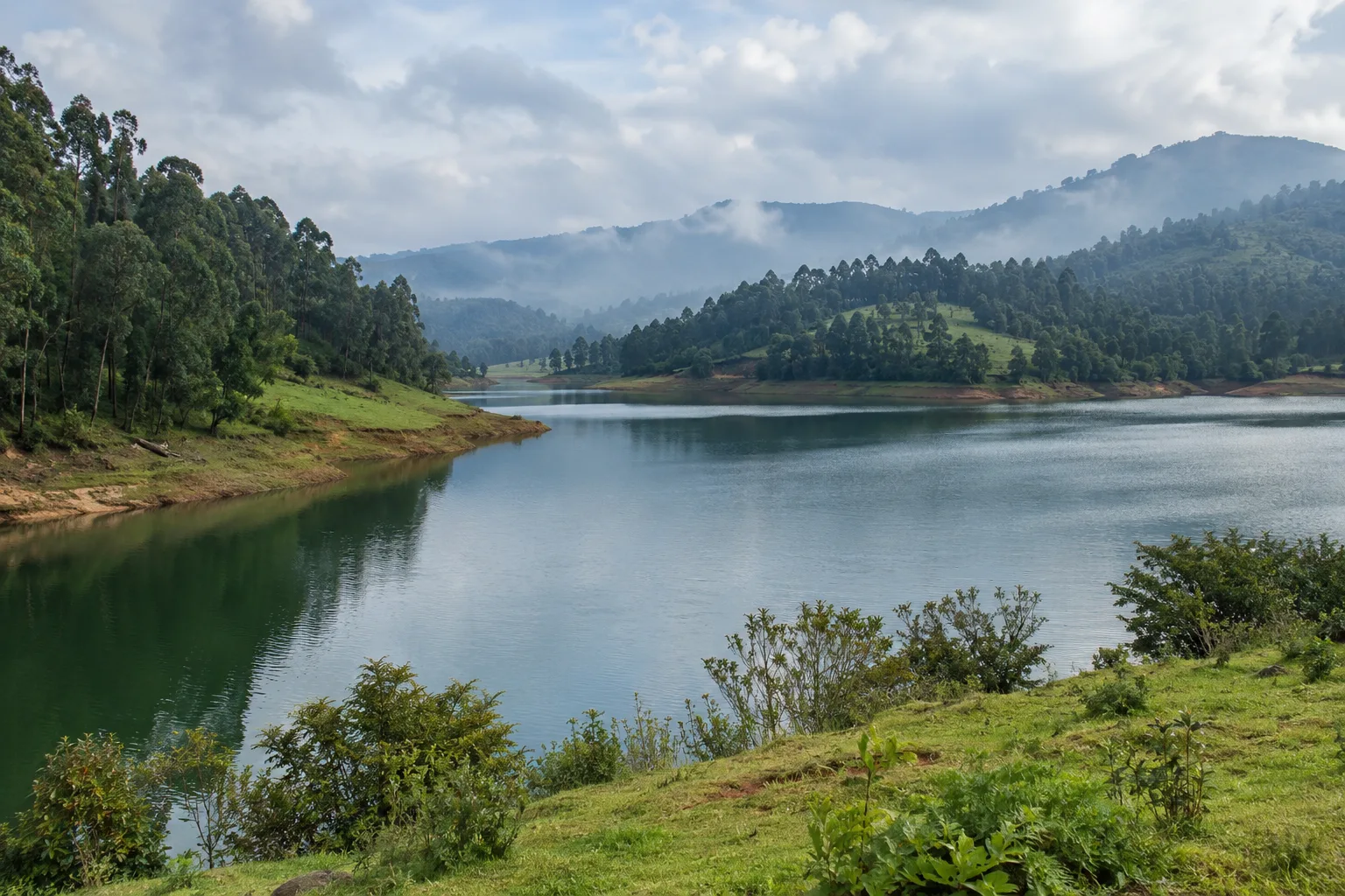 Photorealistic view across Pykara Lake and the surrounding Nilgiri hills