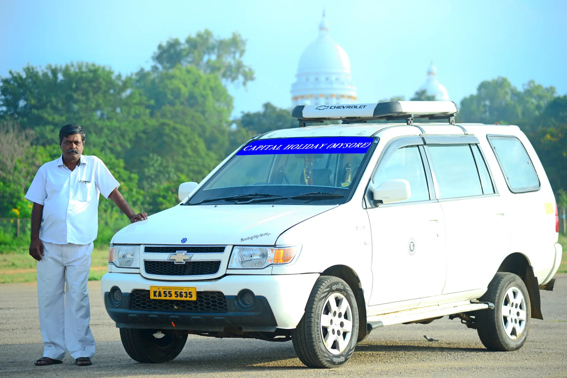 Mysore Travel Taxi driver beside a prepared SUV